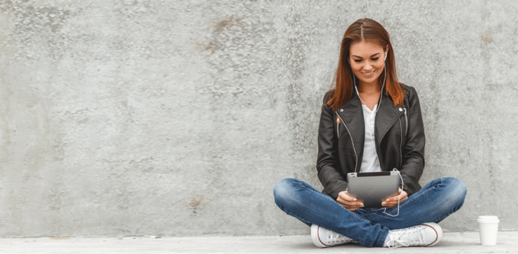 Woman sitting with tablet in lap